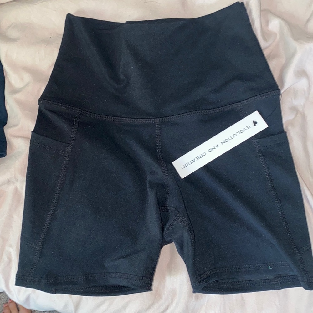 Black biker shorts, 5” inseam, side pockets on both pant legs